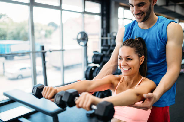 istock Personal trainer giving instructions in gym 1011268200