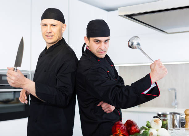 istock Two male kitchener in uniform are standing in the kitchen 1011270610