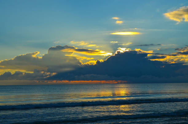 Dramatic light mood with orange illuminated clouds during a sunrise over the Baltic Sea in Binz on Ruegen, Germany