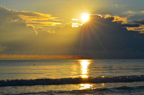 istock Dramatic light mood with orange illuminated clouds during a sunrise over the Baltic Sea in Binz on Ruegen, Germany 1011271628