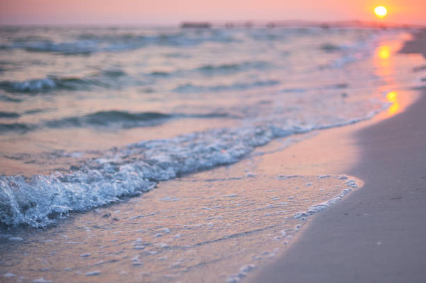 istock Blur sea beach with bokeh sun light wave abstract background. 1011276188