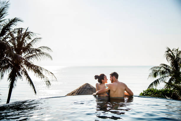 istock Couple relaxing in a swimming pool 1011276722