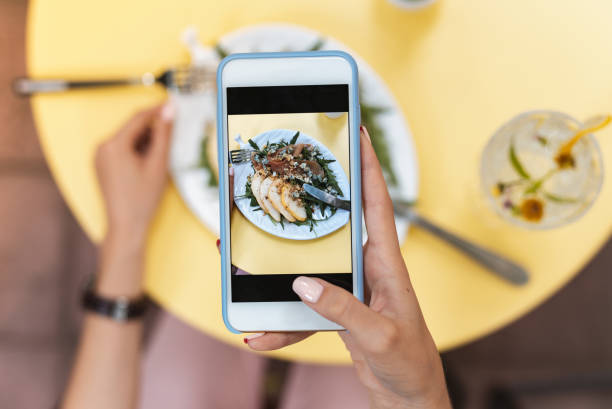istock Freelancer making photo of her vegetable salad standing on yellow table 1011277104