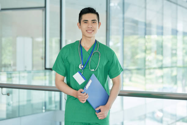 istock Cheerful Asian doctor with clipboard 1011277284