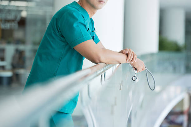 Crop doctor with stethoscope near railing