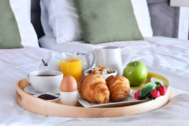 istock Breakfast on tray in bed in hotel room 1011279830
