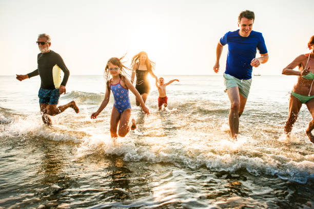 istock Family playing at the beach 1011280394