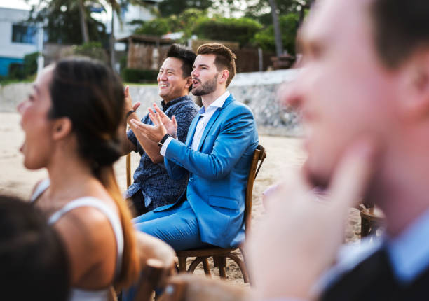 istock Guests attending a beach wedding ceremony 1011283008