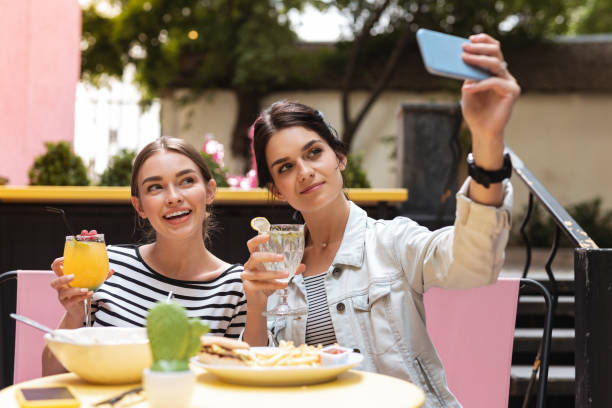 istock Two businesswomen making photo while having lunch together 1011284636