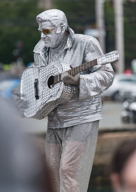 Paris, France - May 23, 2014: Young street artist, who likens herself to make-up artist sculpture with make-up, attracts the attention of tourists.