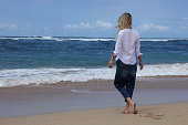 Young woman walking near ocean, summer holiday, beach vacation concept, Bali , Indonesia