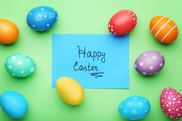 istock Inscription Happy Easter with painted eggs on green background 1011287102