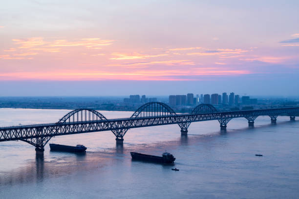 istock jiujiang yangtze river bridge with sunset glow 1011287758