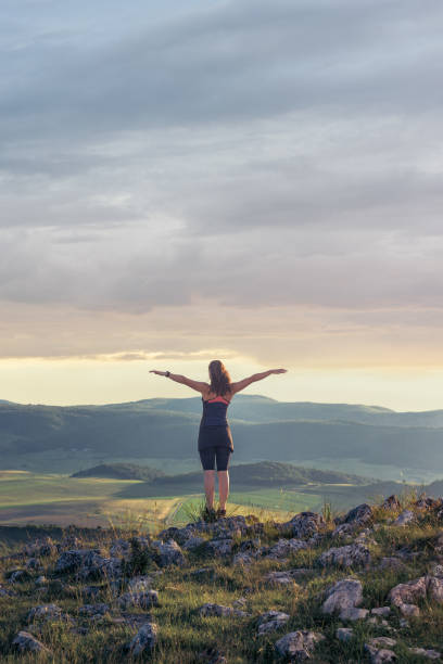 istock Young woman with arms raised up 1011292974