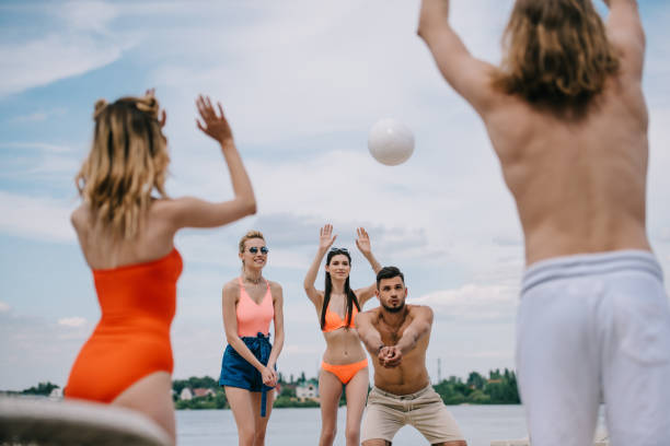 istock young people playing with ball on beach 1011297292