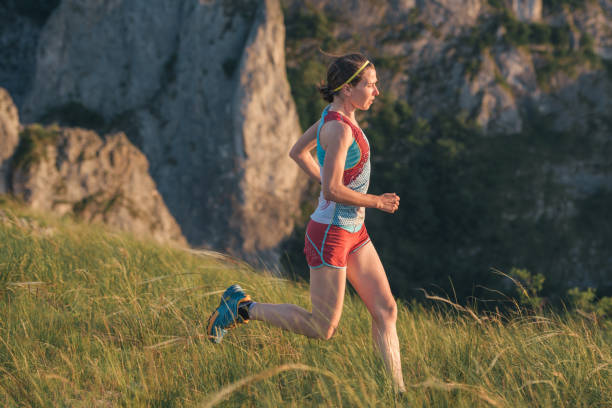istock young woman trail running outdoors in nature 1011297570