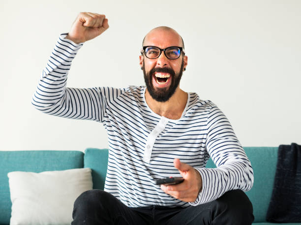 istock Cheerful person sitting on the couch 1011298076