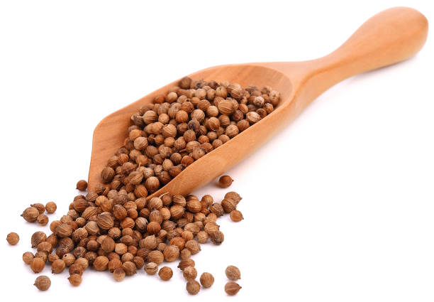istock Coriander seeds in wood spoon on white background 1011298178