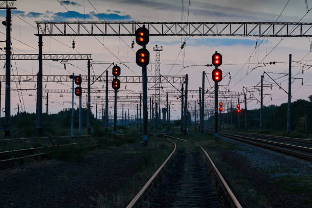 railroad traffic lights and infrastructure during beautiful sunset, colorful sky, transportation and industrial concept railroad traffic lights and infrastructure during beautiful sunset, colorful sky, transportation and industrial concept railway signal stock pictures, royalty-free photos & images