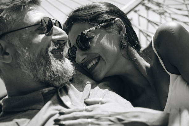 istock Couple resting together in a hammock 1011313812