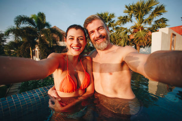 istock Couple taking a selfie in a pool 1011313894