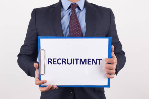 istock Man showing paper with RECRUITMENT text 1011320760