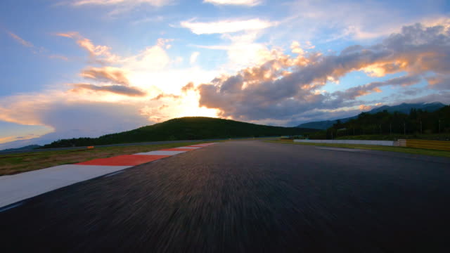 Driving on a race track at sunrise