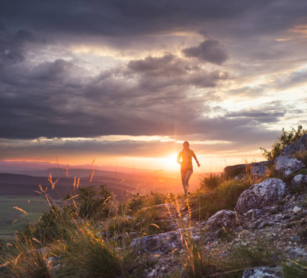 woman running uphill in the mountains