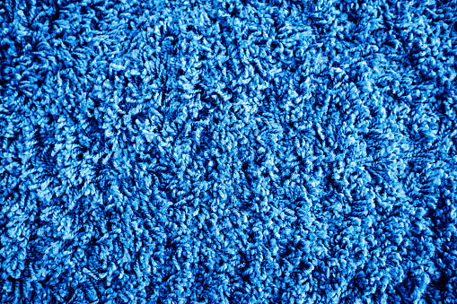 Background of a carpet covering of textiles in close-up of blue color.