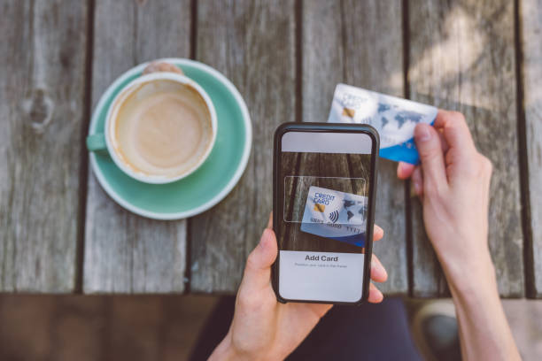 istock Woman adding credit card into digital wallet 1011343466