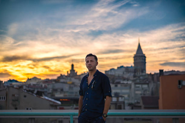 istock Man watching the sunset Istanbul Galata tower 1011344542