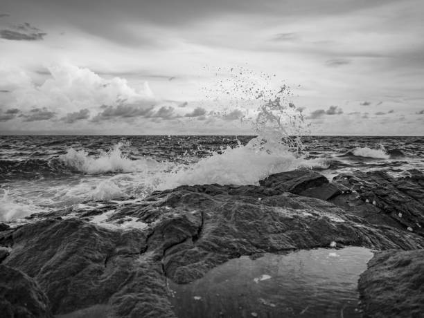 istock Ocean wave crashing Onto Rocky in the Blue ocean 1011361432