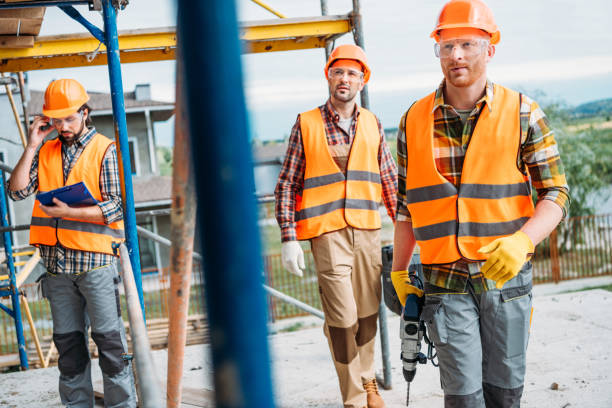 istock group of builders working together at construction site 1011361454