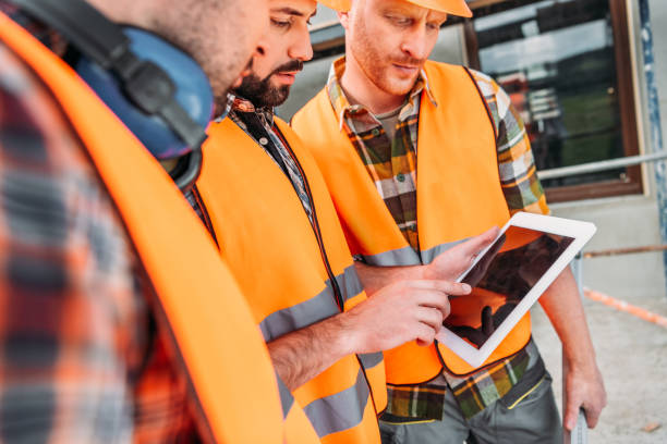 istock close-up shot of group of builders using digital tablet at construction site 1011361780
