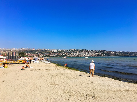 Buyukcekmece, Istanbul, Turkey - July 28, 2018: A sunny summer day in beach and the people having their time with relaxing.