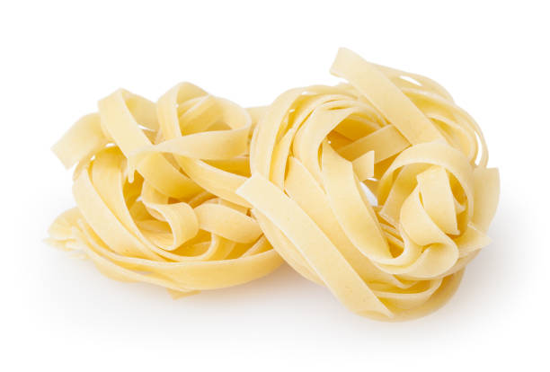 istock Uncooked nests of tagliatelle pasta isolated on white background with clipping path 1011366208