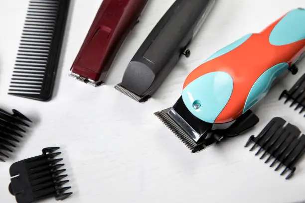 Assorted haircutting clippers laying on a table top. Image shot with Canon 5D Mark lV, 24-105mm f/4L IS USM lens.