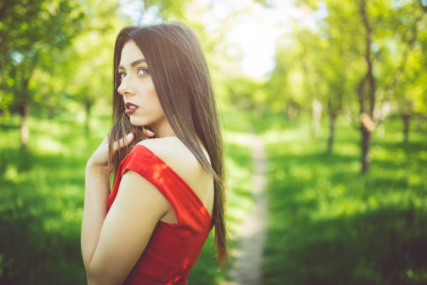 istock White girl in red gown 1011372704