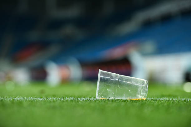 istock Plastic trash can on the turf on a soccer field 1011375154