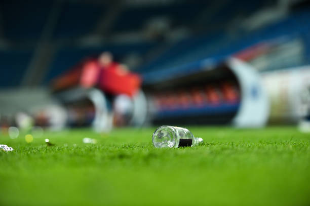 istock Plastic trash can on the turf on a soccer field 1011375162