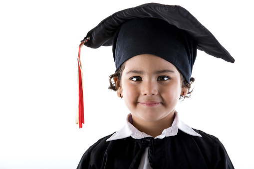 Portrait of little Indian girl in graduation gown