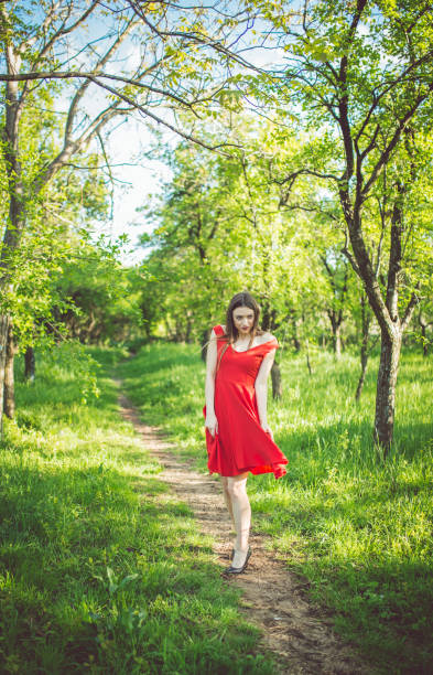 istock White girl in red gown 1011376696