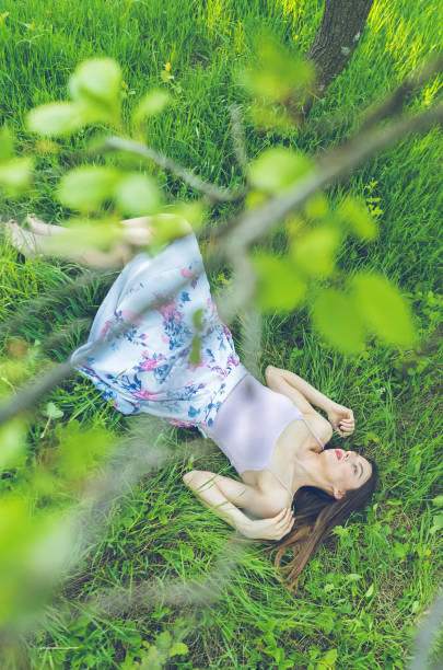 istock Girl in Grass Seen Through Branches 1011392094