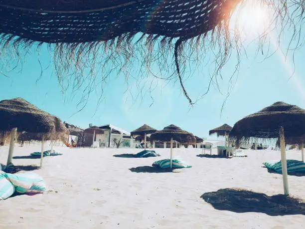 Cool beach bar with bean bags and sun umbrellas