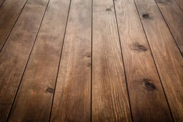 High angle view of a rustic wooden table with vertical stripes. Ideal for product display on top of the table. Predominant color is brown. DSRL studio photo taken with Canon EOS 5D Mk II and Canon EF 24-105mm f/4L IS USM Wide Angle Zoom Lens