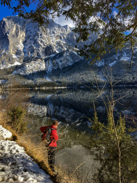 istock Young Man Enjoying Relaxing Outdoors in Snowy Winter Landscape 1011403626