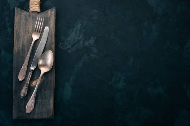 istock Old cutlery. On a black stone background. Top view. Free space for text. 1011403718