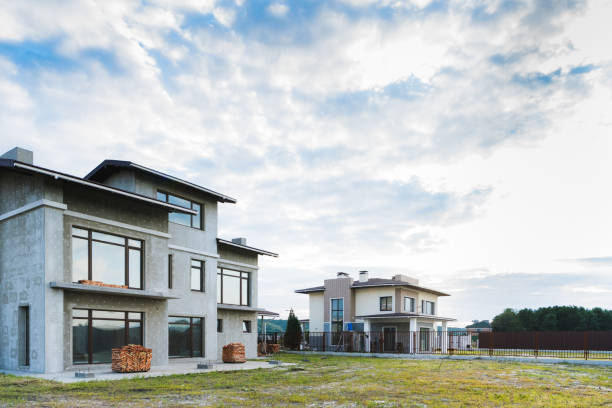 istock modern buildings with green yards on cloudy day 1011403898