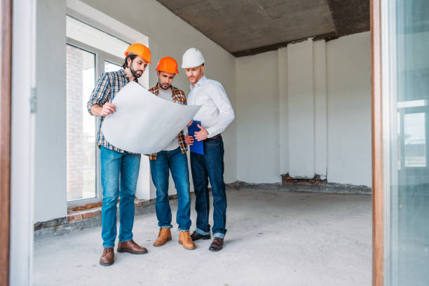 istock group of architects with blueprint having conversation inside of constructing building 1011404042