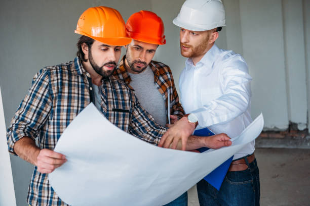 istock group of adult architects with blueprint having conversation inside of constructing building 1011404044